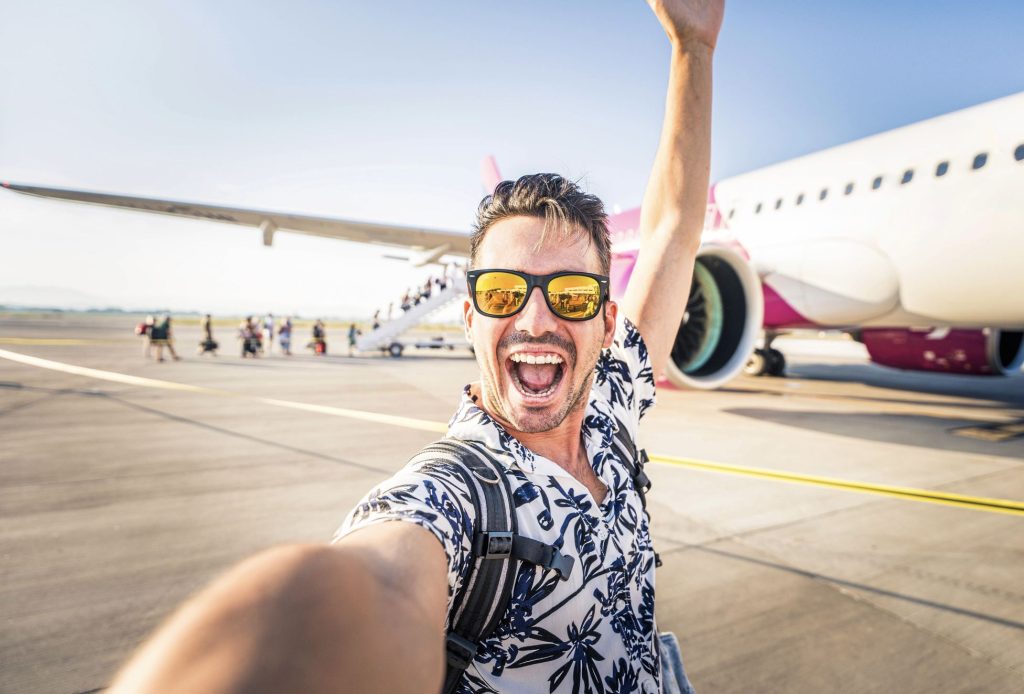 Man celebrating overcoming fear of flights