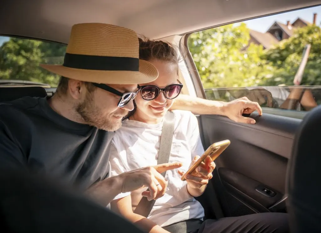 Couple Planning Trip on google street view from car