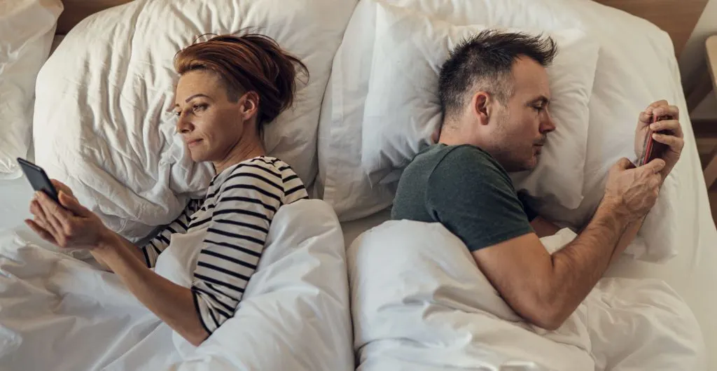 Couple setting alarms for morning flight