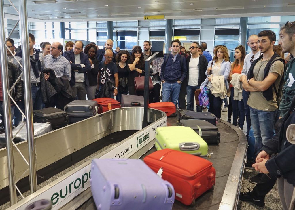 People waiting for luggage hoping their bags aren't lost