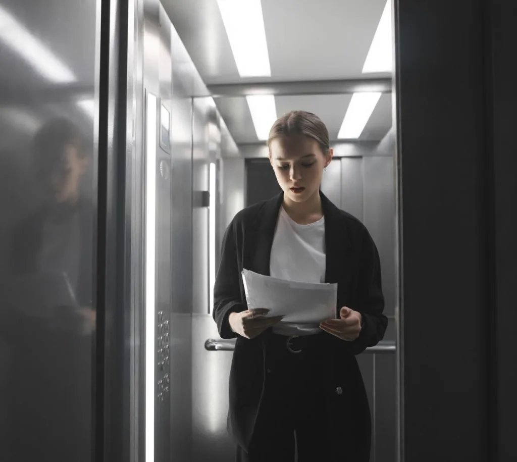 C:\Users\Home\Desktop\Reading papers in elevator.jpg