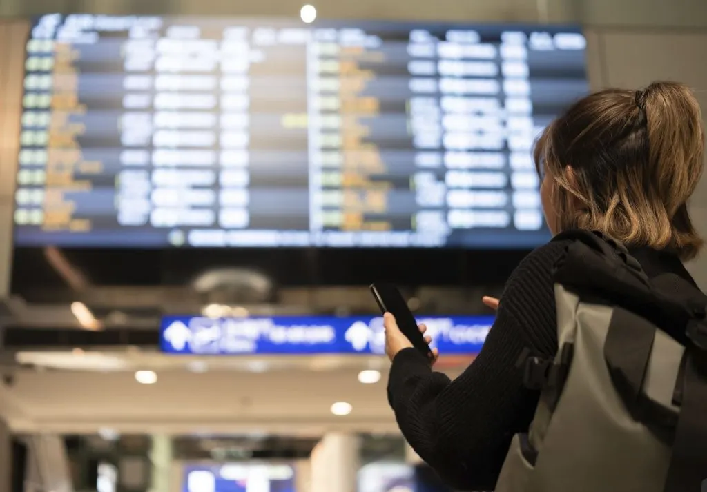 Woman looking up gate number