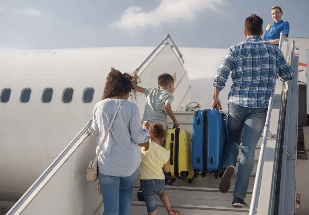 family boarding a plane